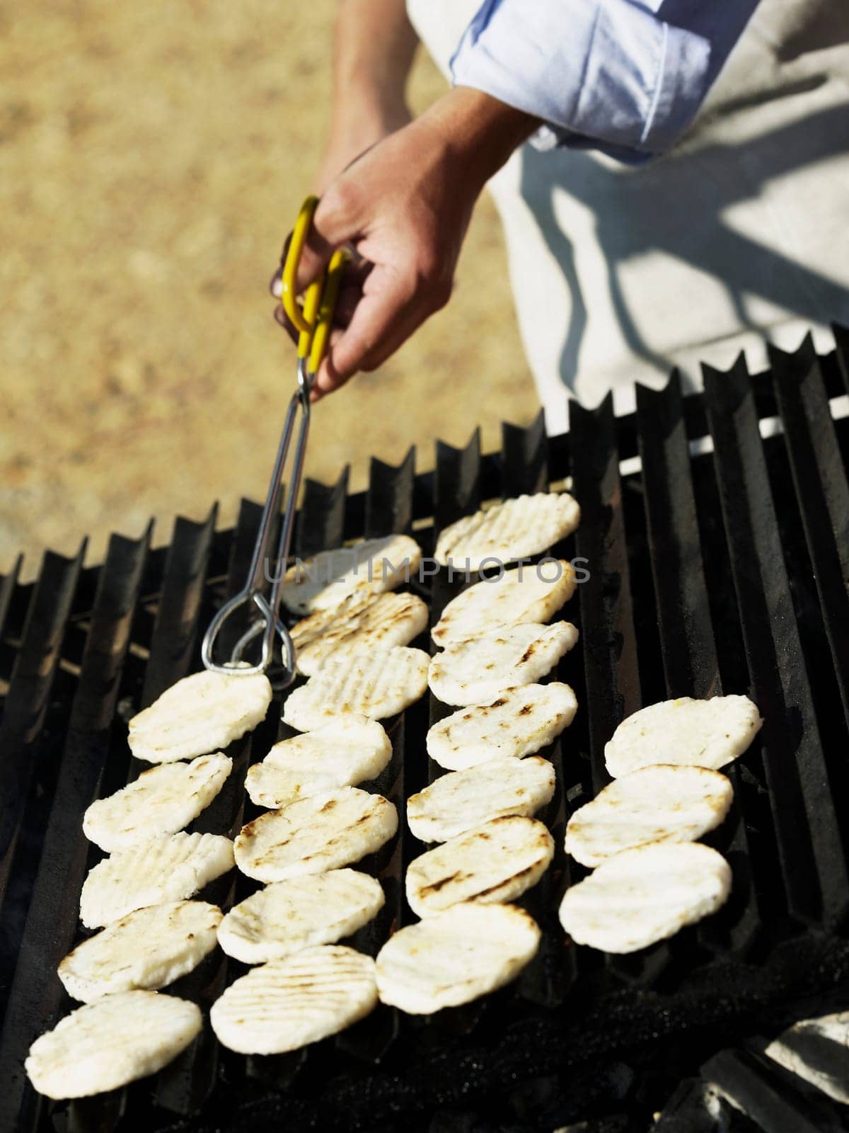 Close-up of a man cooking on a barbeque grill