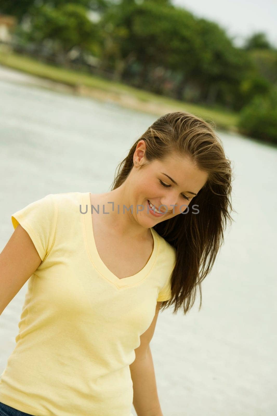 Close-up of a teenage girl walking on the beach smiling