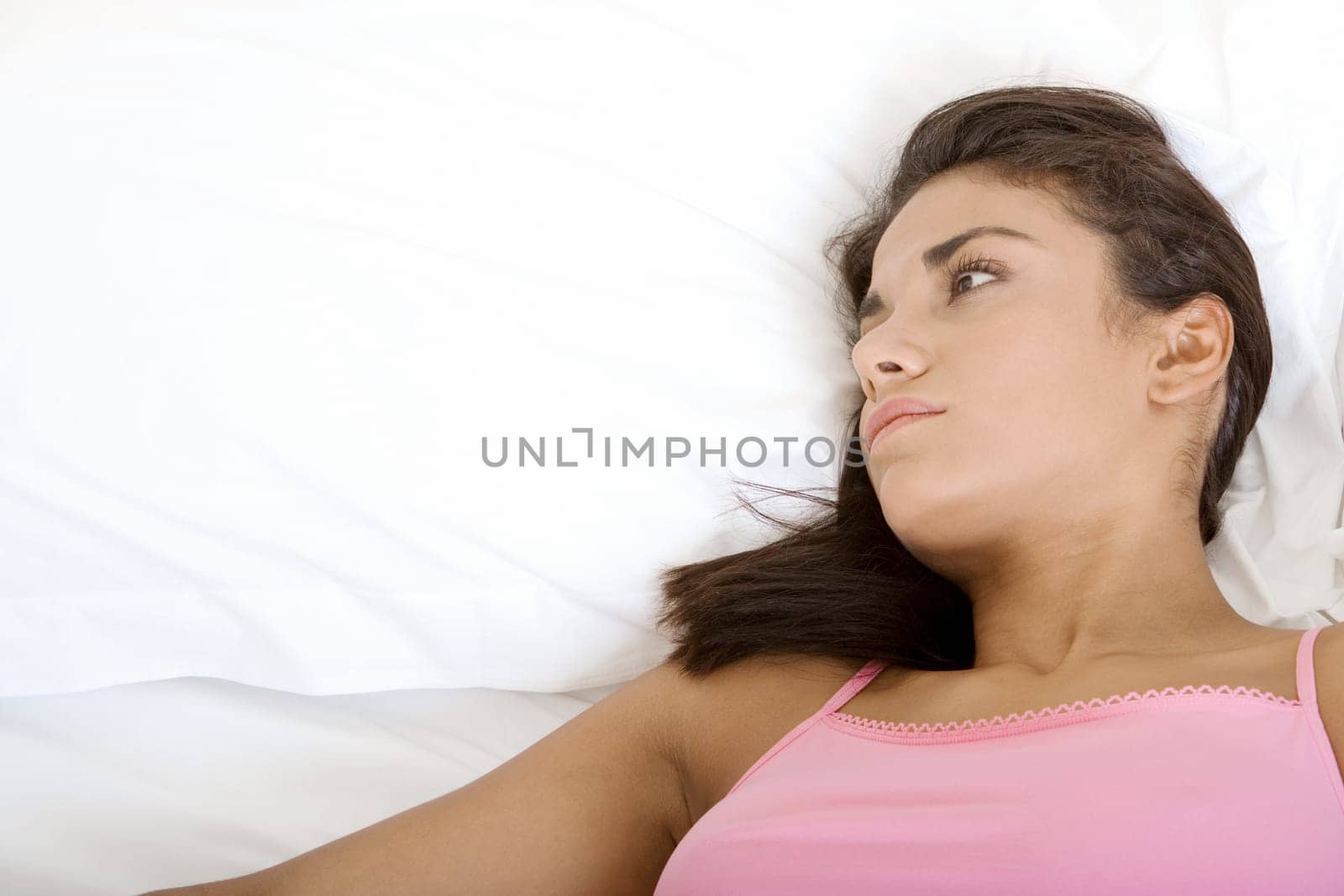 Close-up of a young woman lying down on a bed