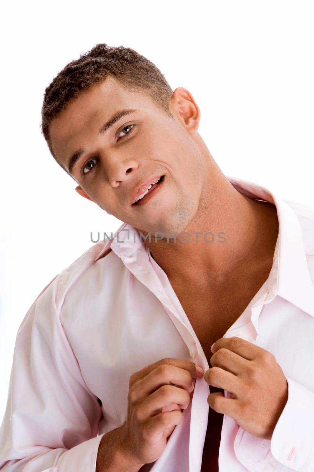 Portrait of a young man buttoning his shirt