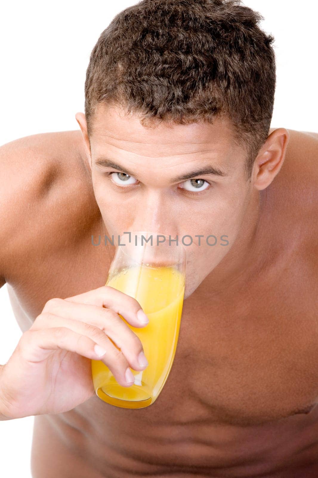 Portrait of a young man drinking a glass of juice