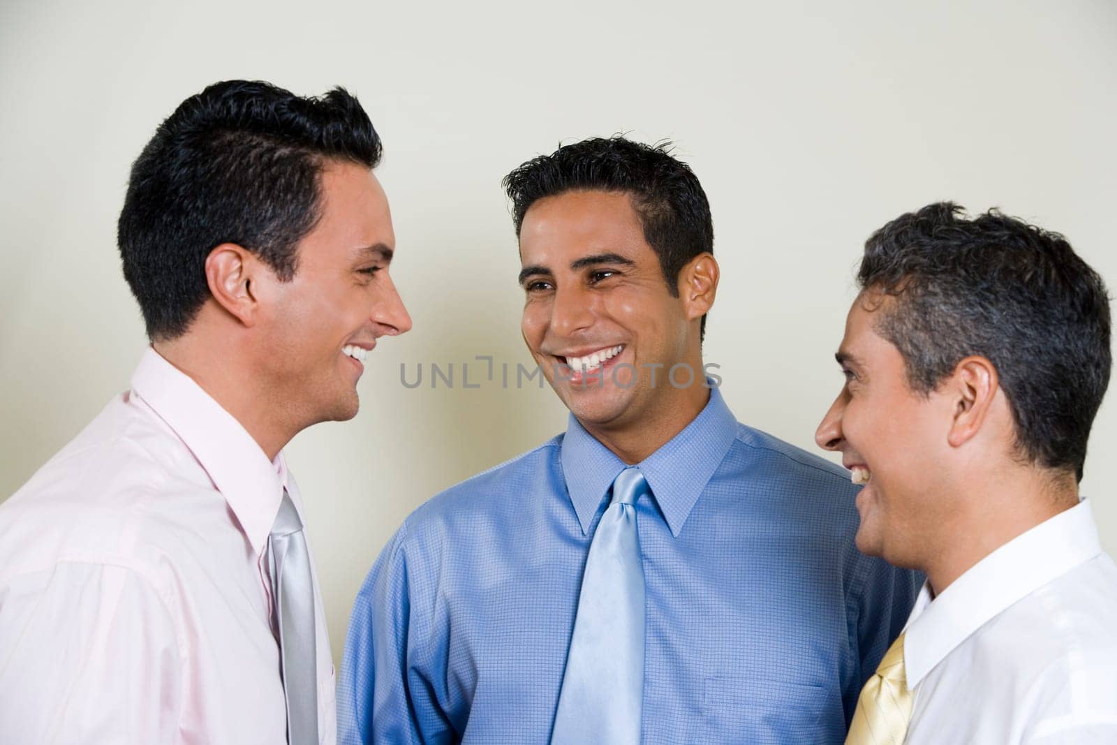 Close-up of three businessmen smiling