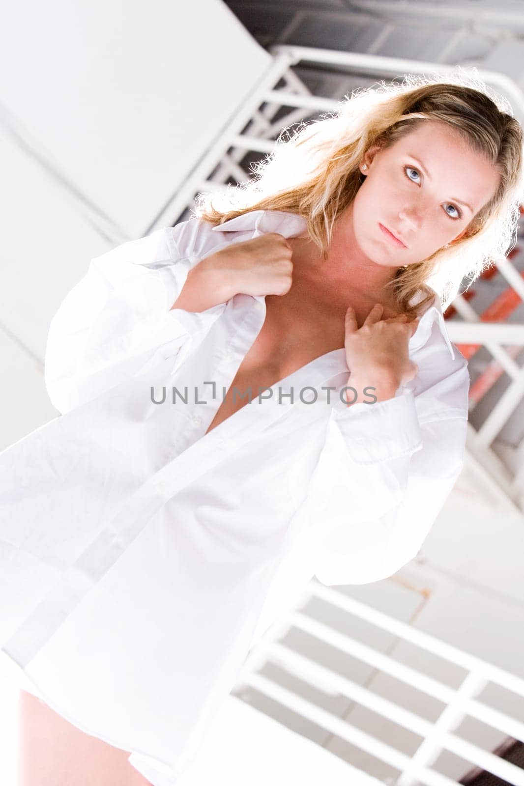Portrait of a young woman holding her shirt collar