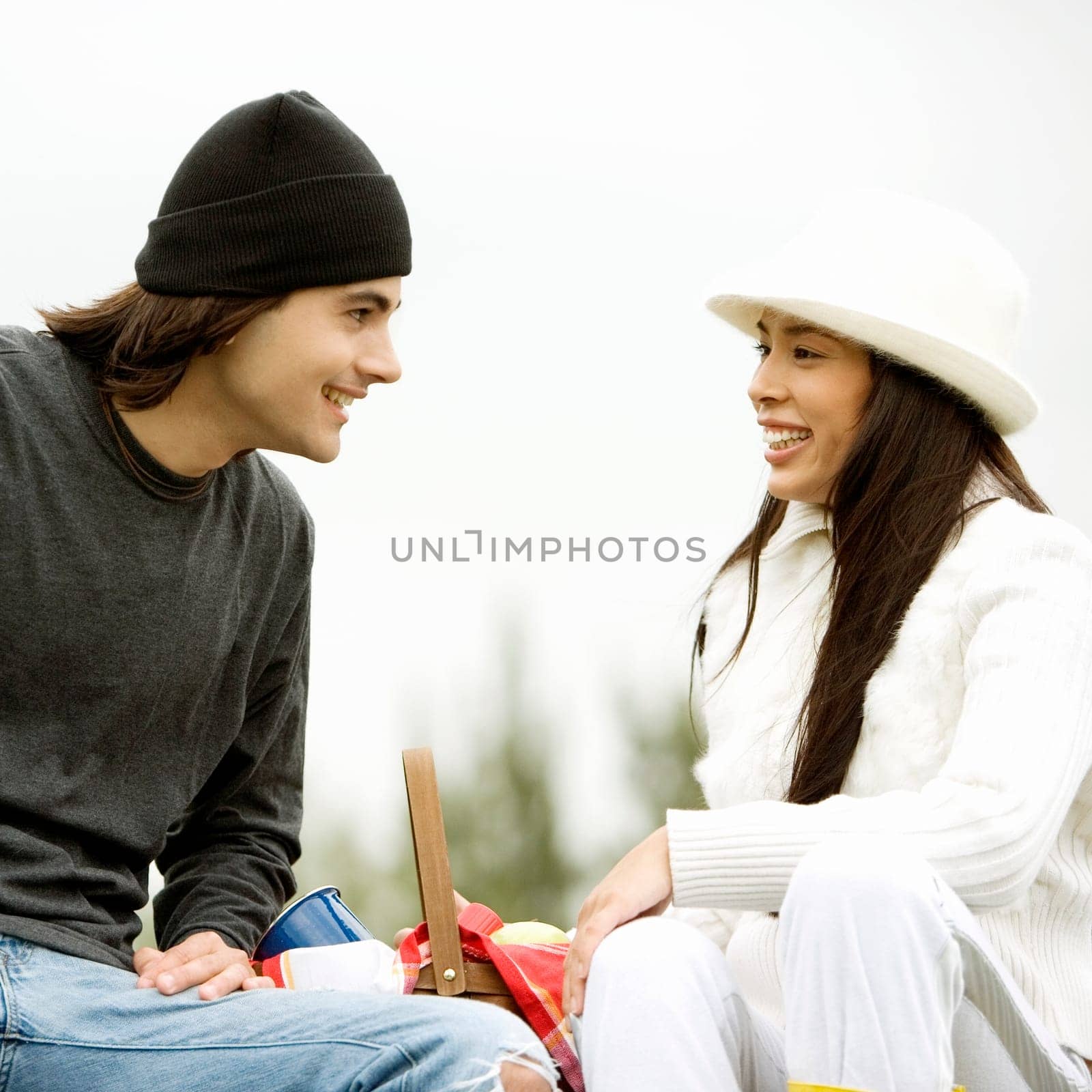 Close-up of a young couple sitting and smiling