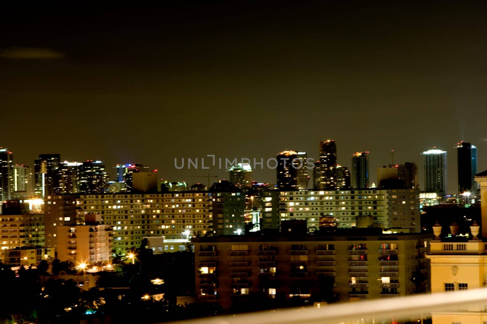 High angle view of buildings lit up at night