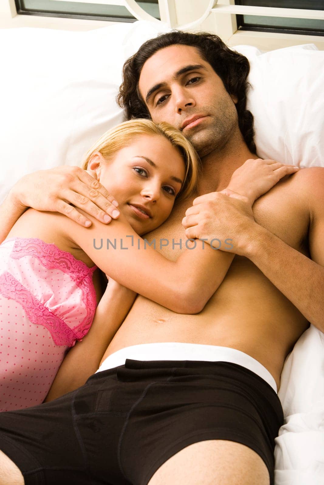 Portrait of a young couple lying on the bed