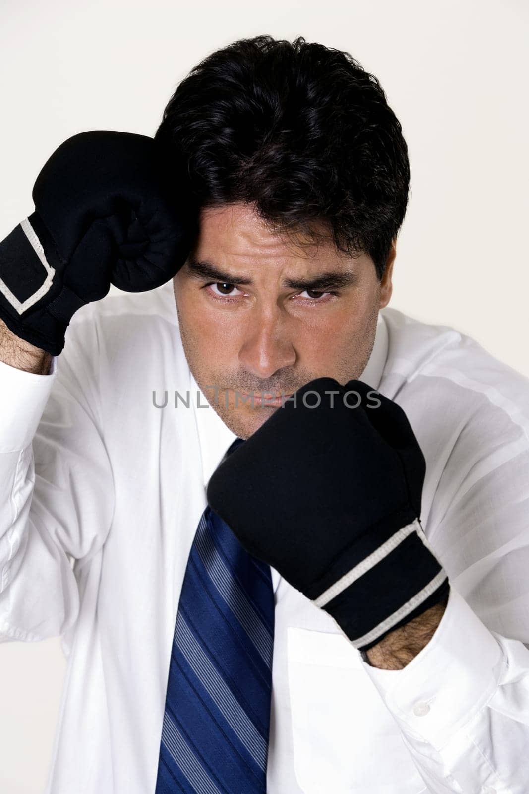 Portrait of a businessman wearing boxing gloves