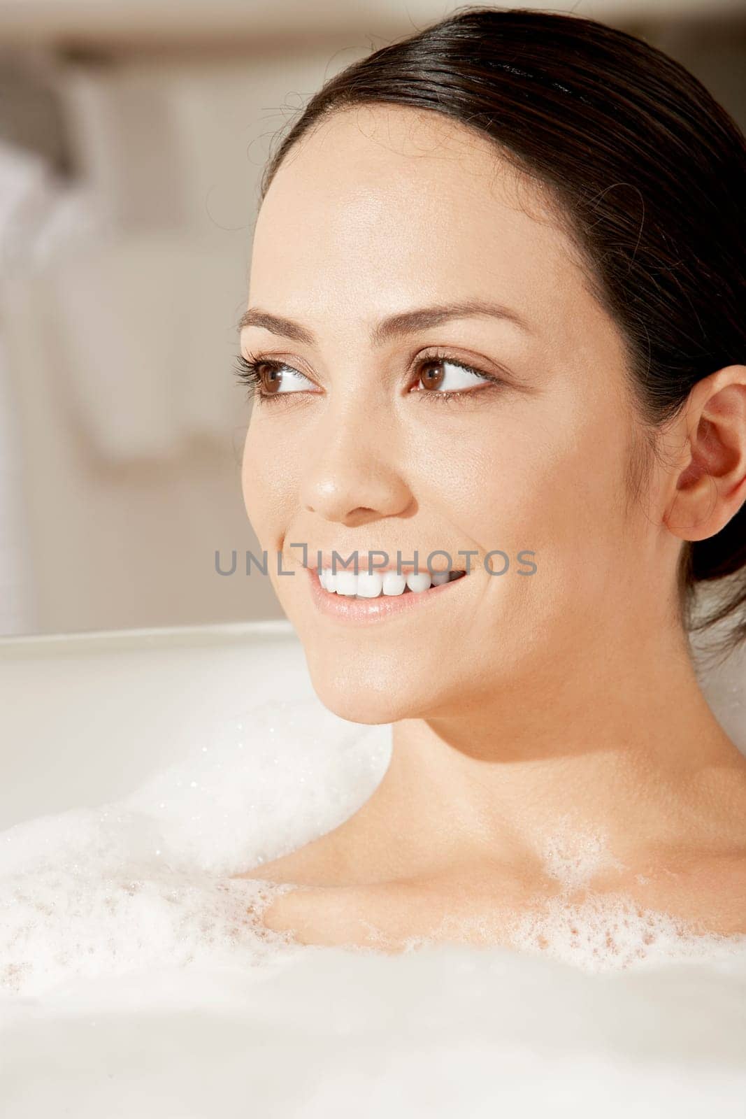 Close-up of a young woman in a bubble bath