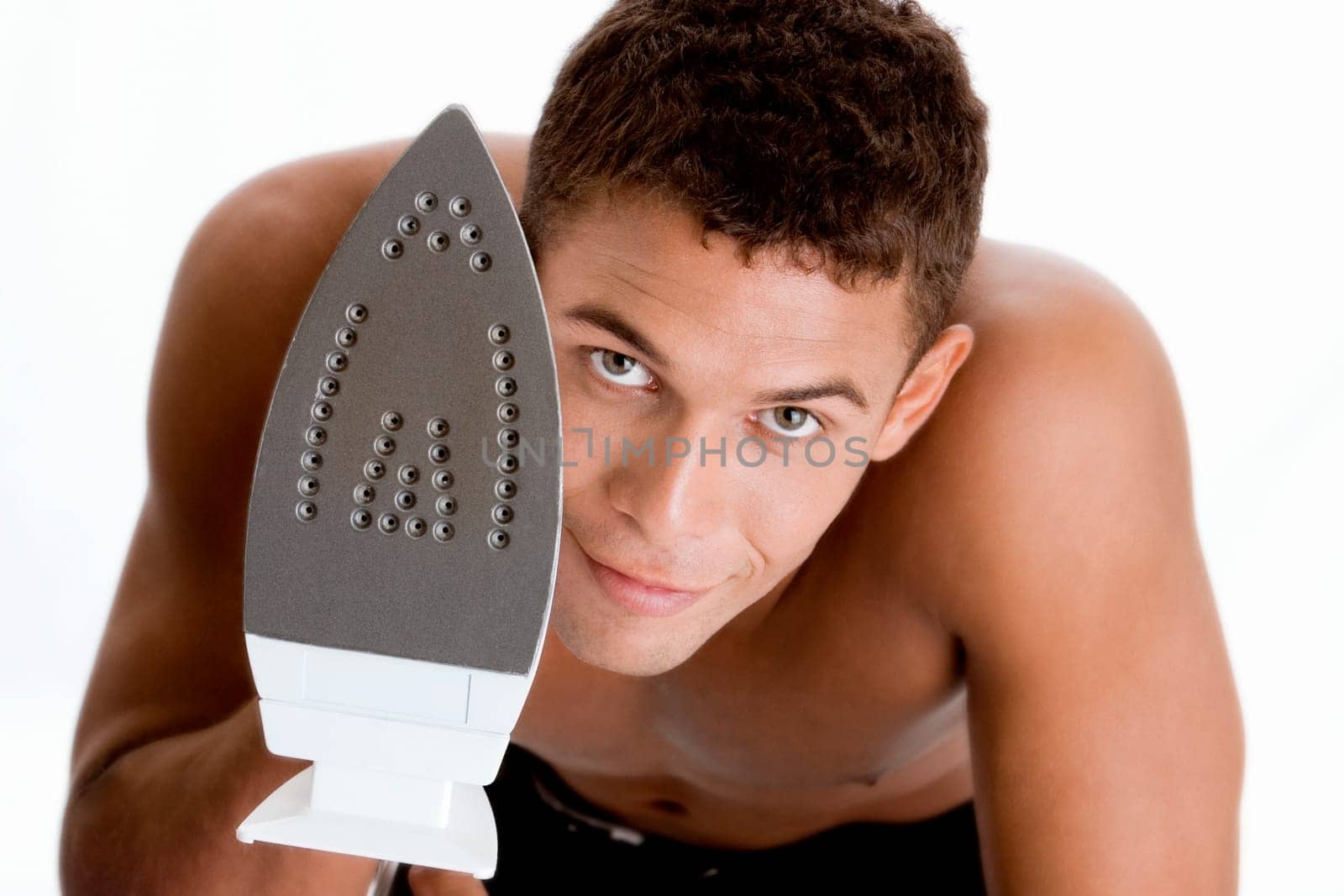Portrait of a young man holding an iron