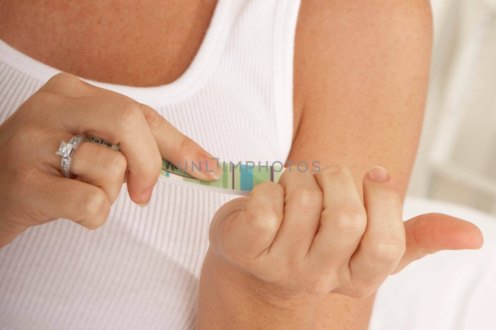 Close-up of a mid adult woman using a nail file