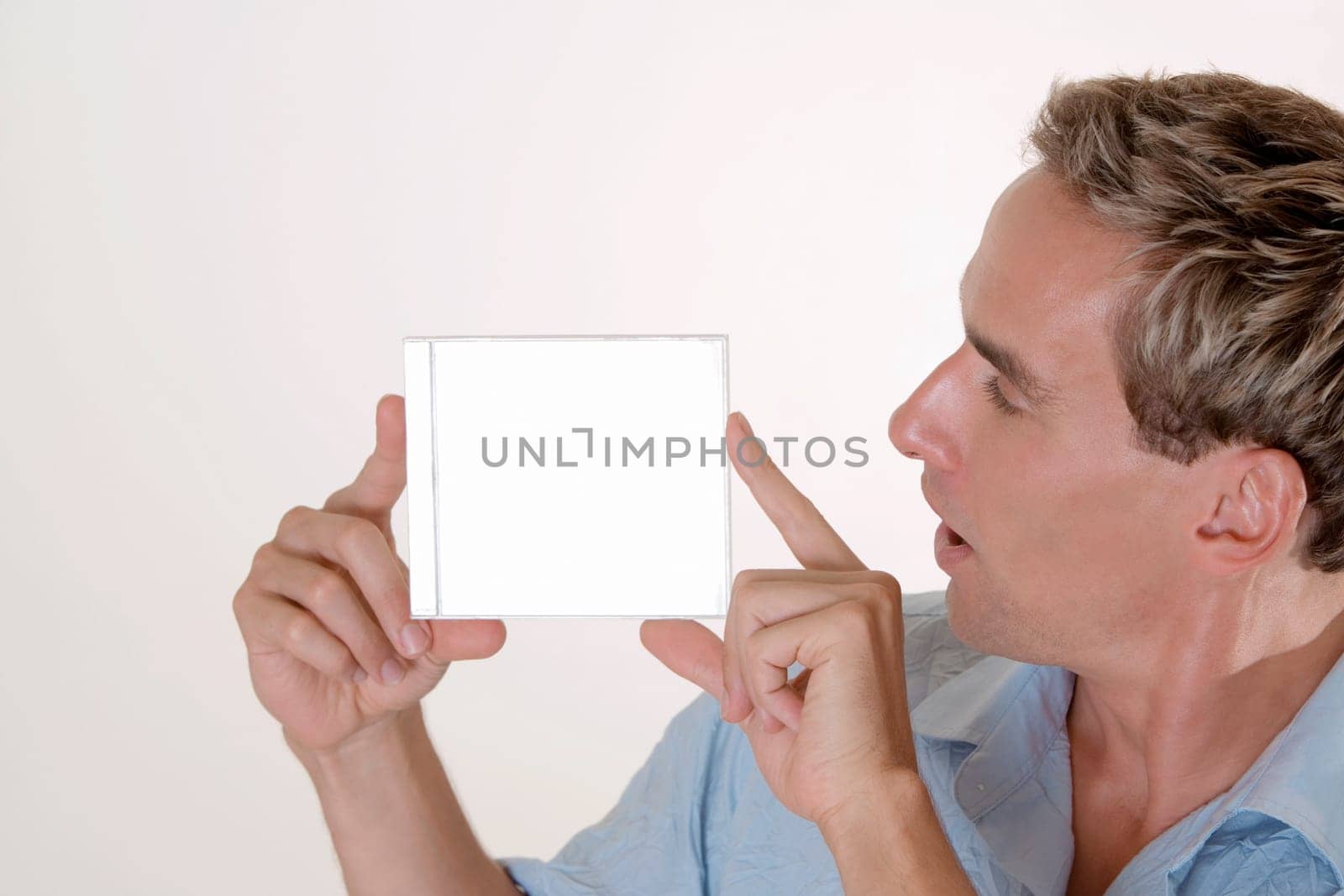 Close-up of a mid adult man holding a CD case