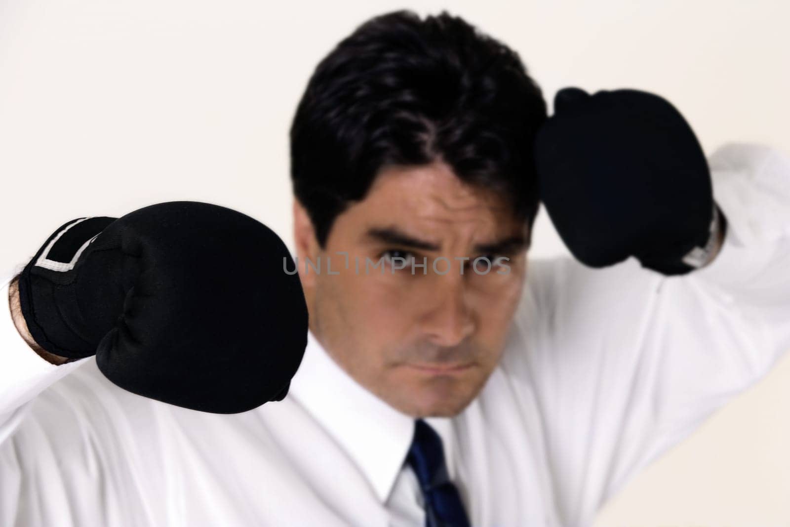 Portrait of a businessman wearing boxing gloves