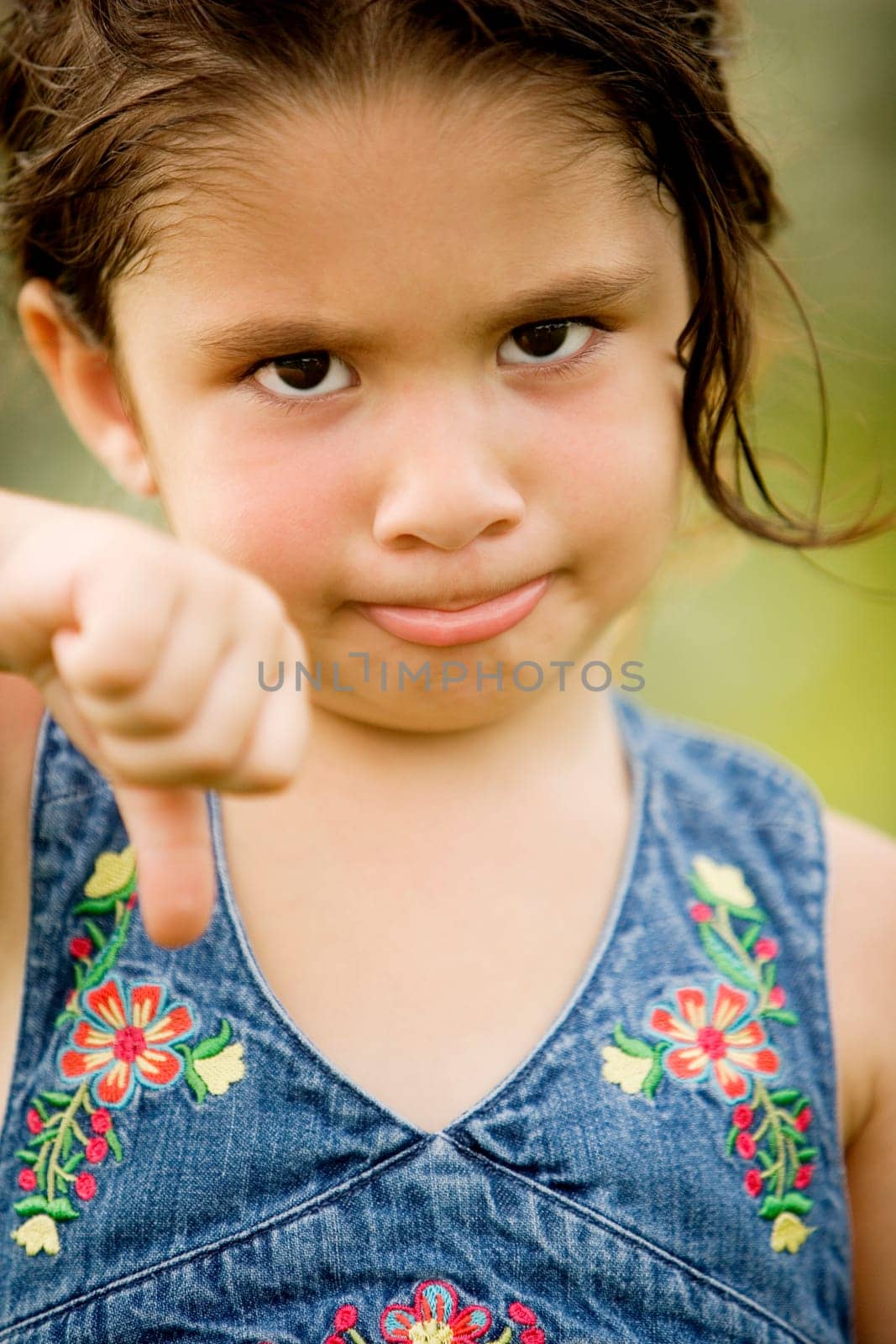 Portrait of a girl showing thumbs down