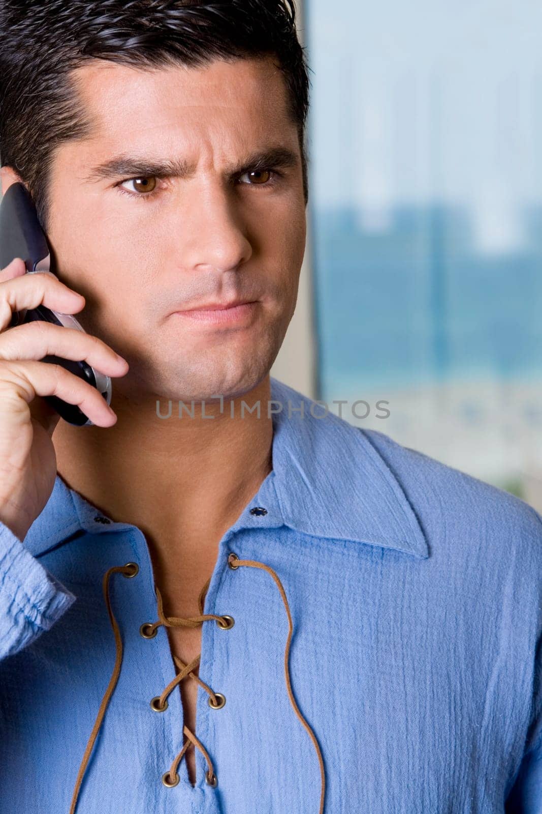 Close-up of a young man talking on a mobile phone