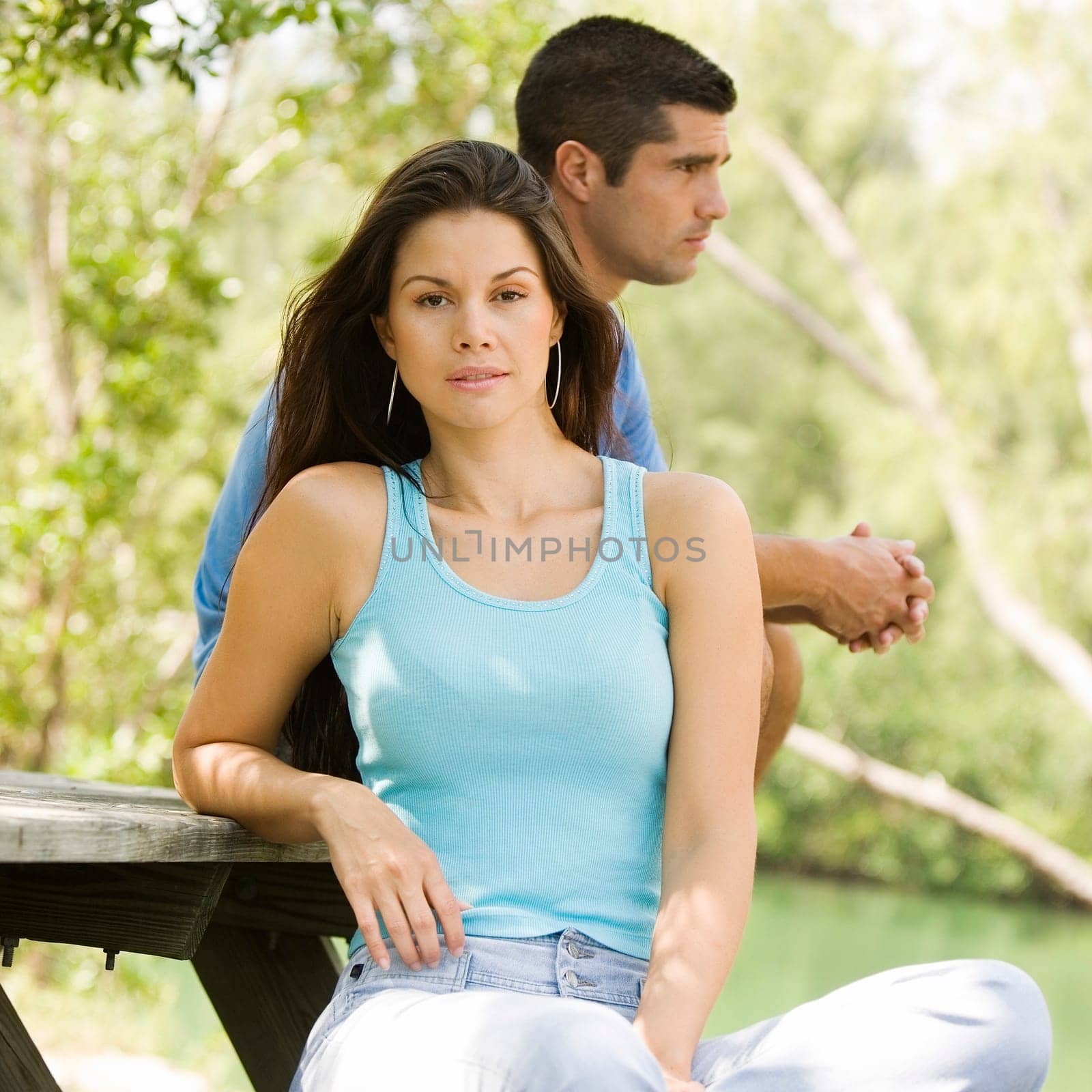 Portrait of a young woman with a mid adult man standing behind her