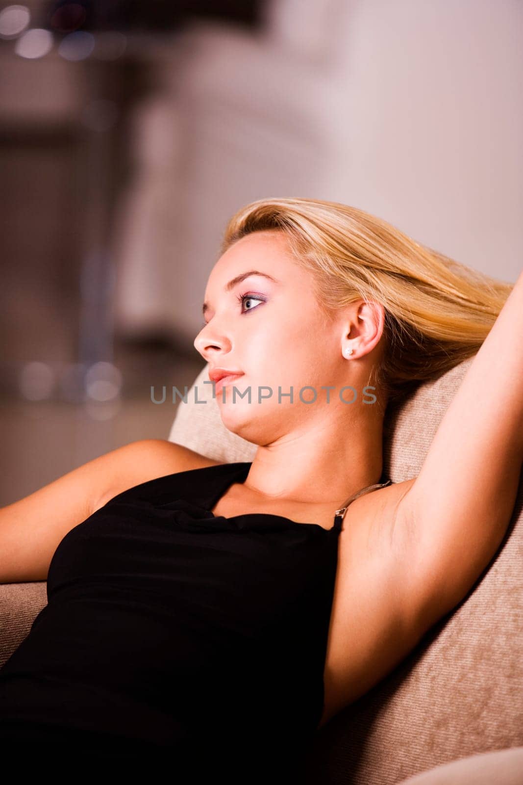Close-up of a young woman reclining on an armchair