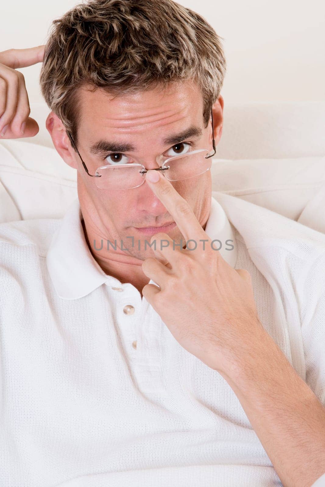 Portrait of a mid adult man adjusting his eyeglasses