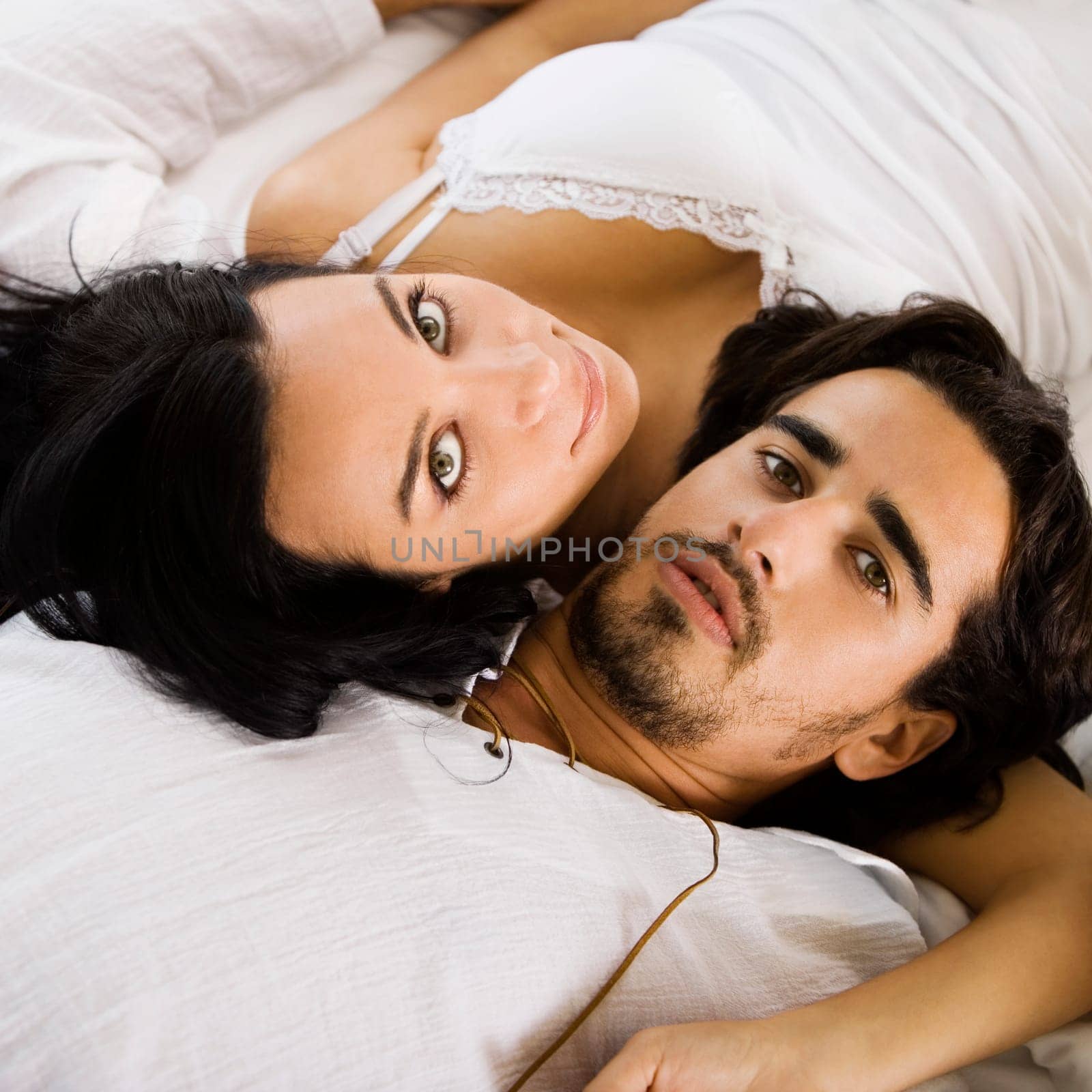 Portrait of a young couple lying on the bed
