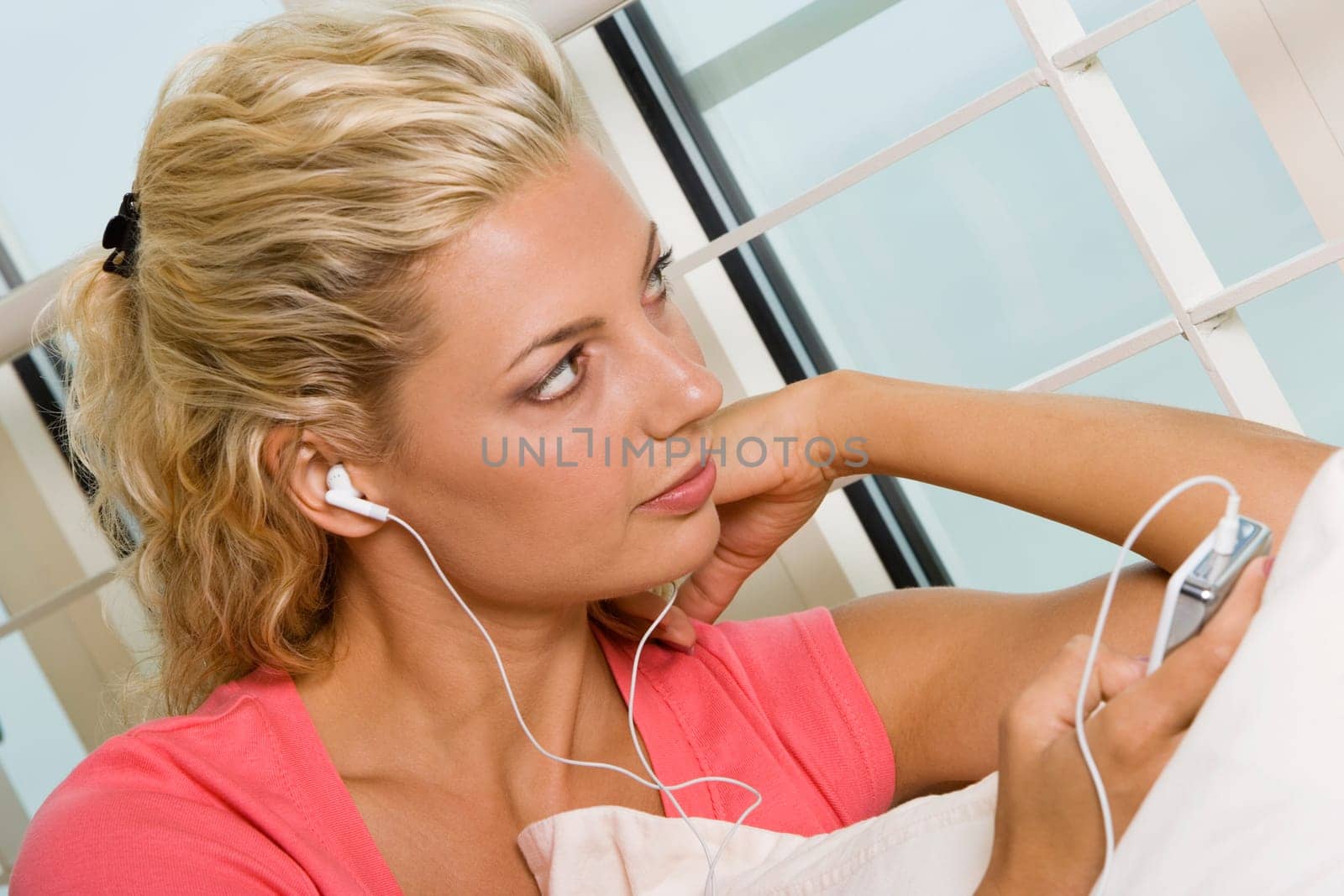 Close-up of a young woman listening to an MP3 player