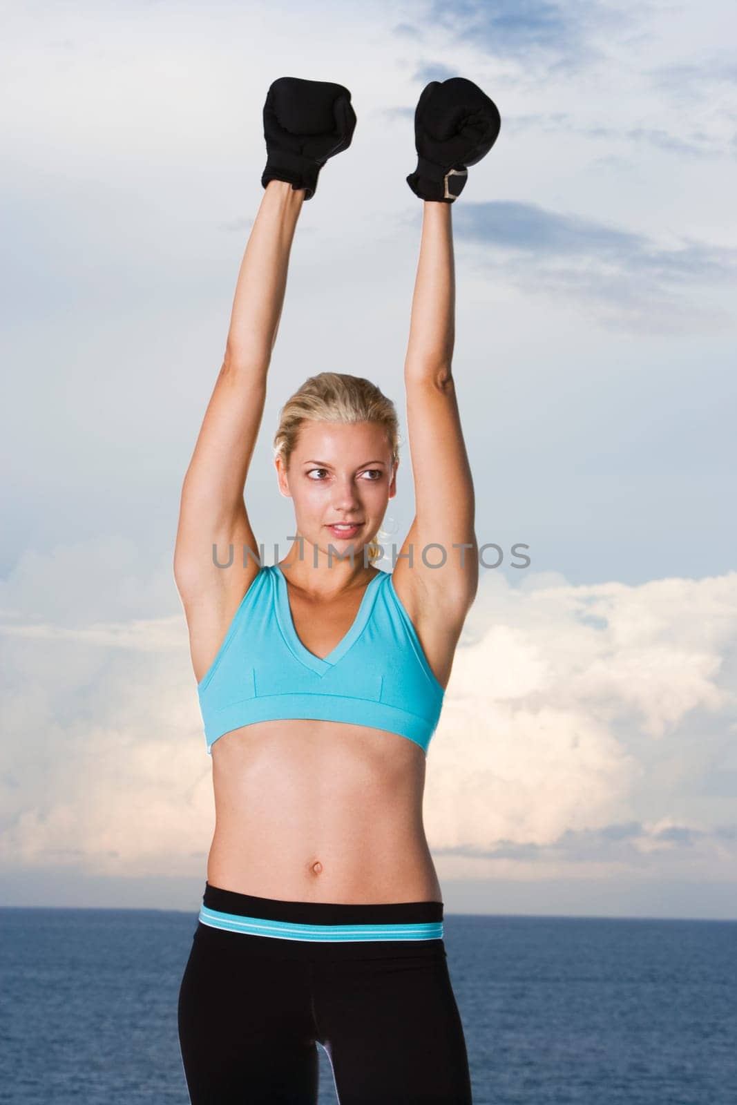 Young woman wearing boxing gloves