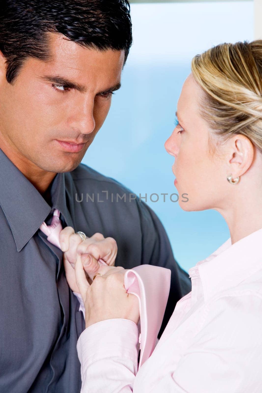 Close-up of a businesswoman adjusting a businessmanŽs tie