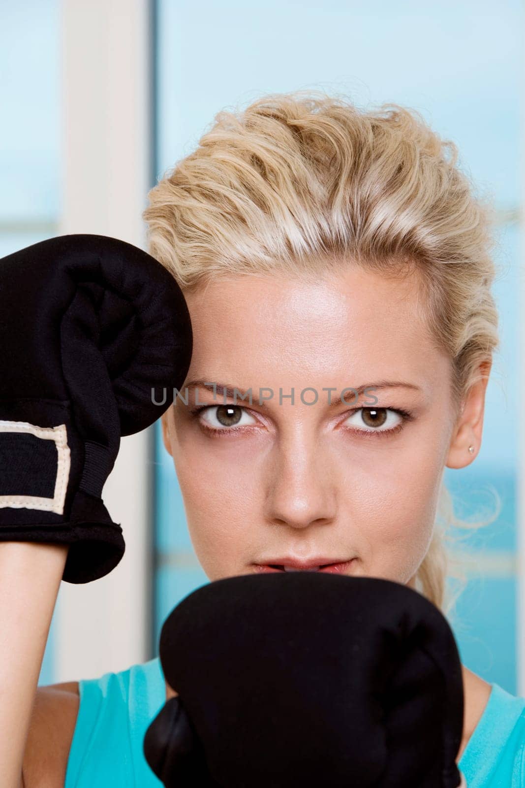 Close-up of a young woman wearing boxing gloves