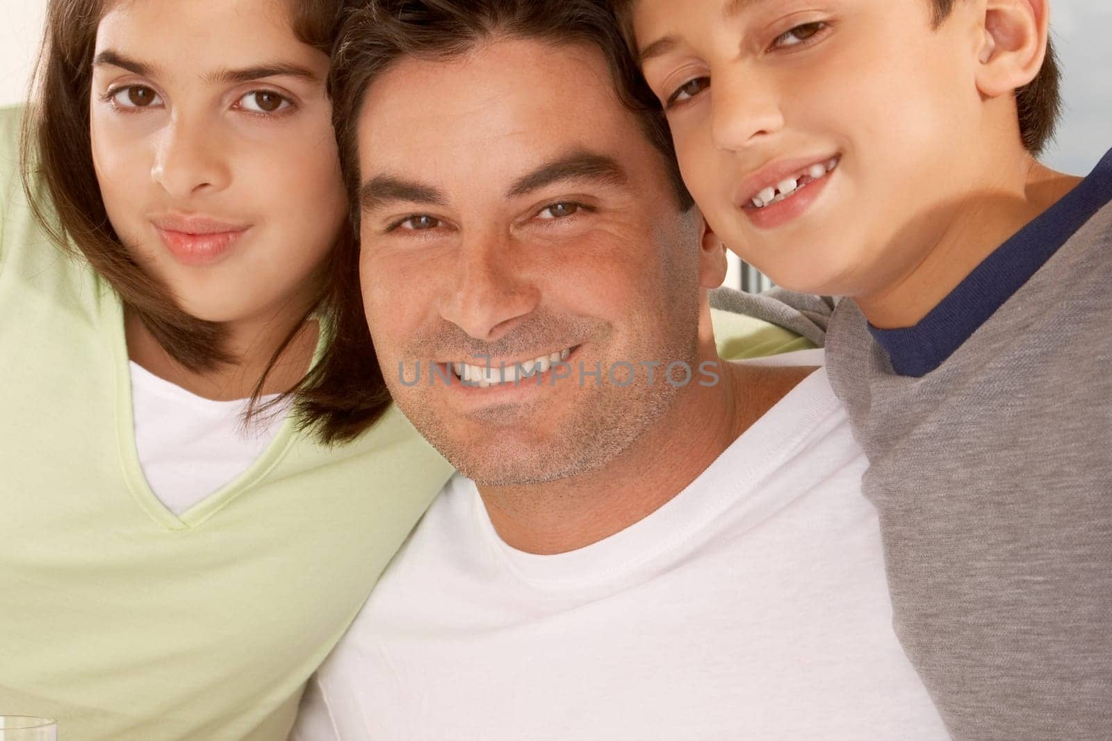 Portrait of a father with his son and his daughter smiling