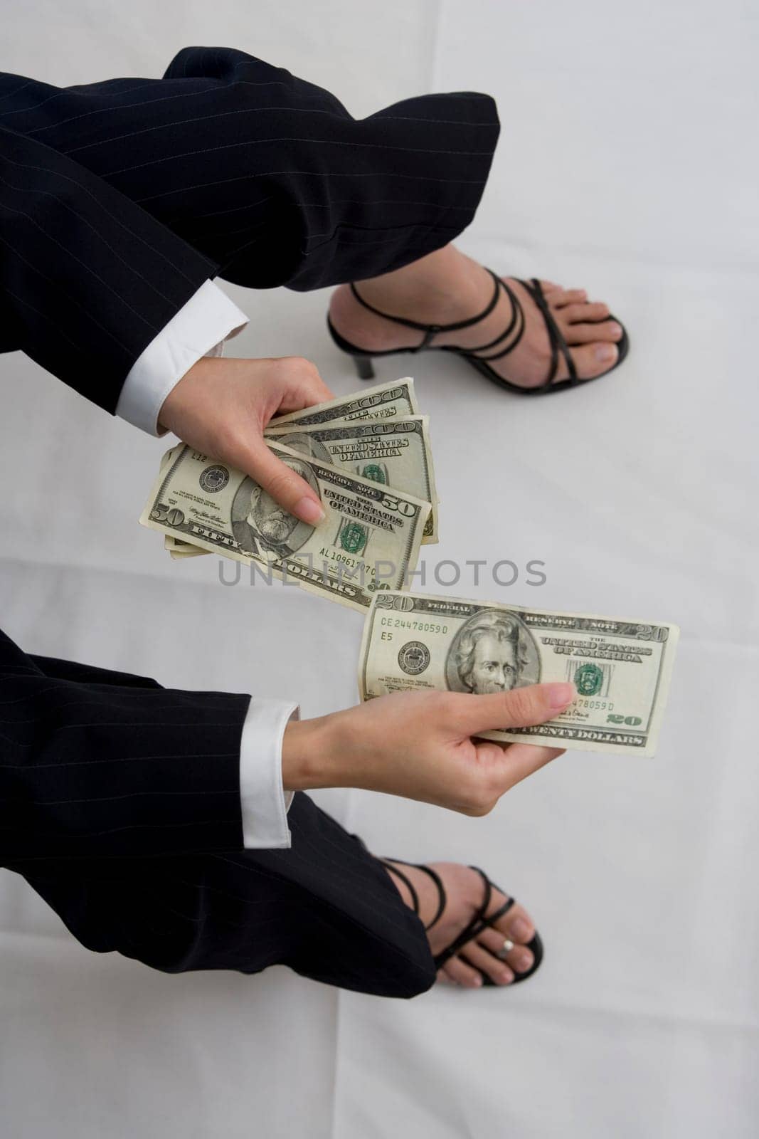 High angle view of a woman holding American dollar bills