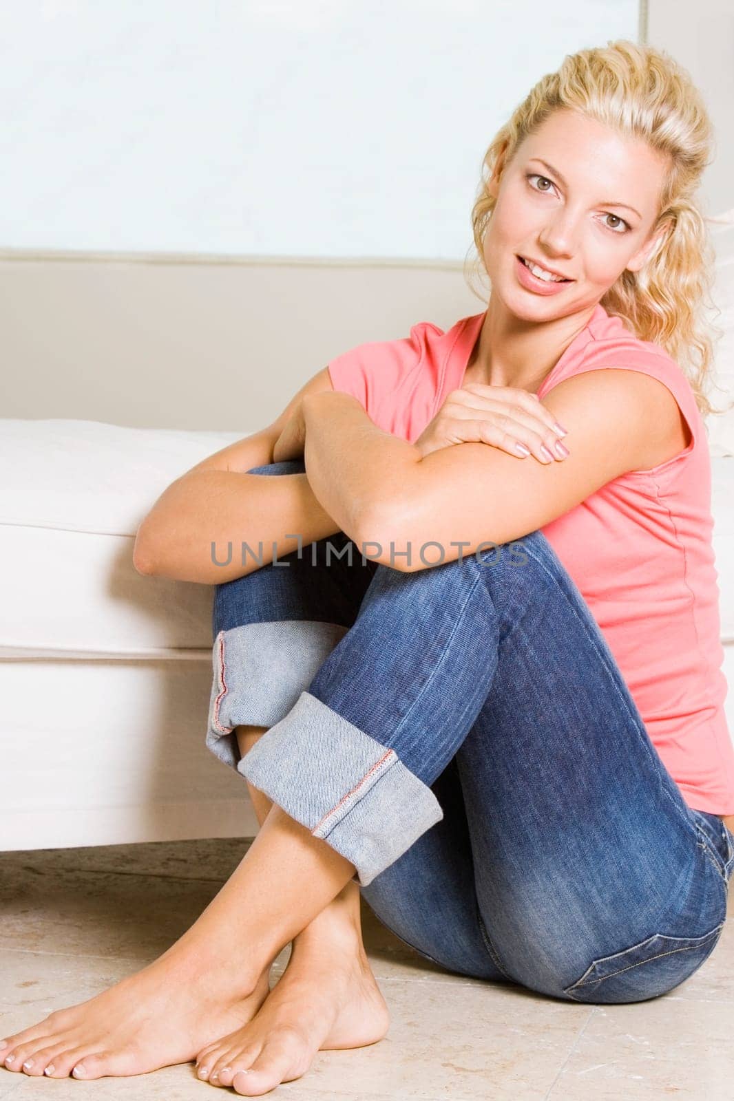 Portrait of a young woman sitting on the floor