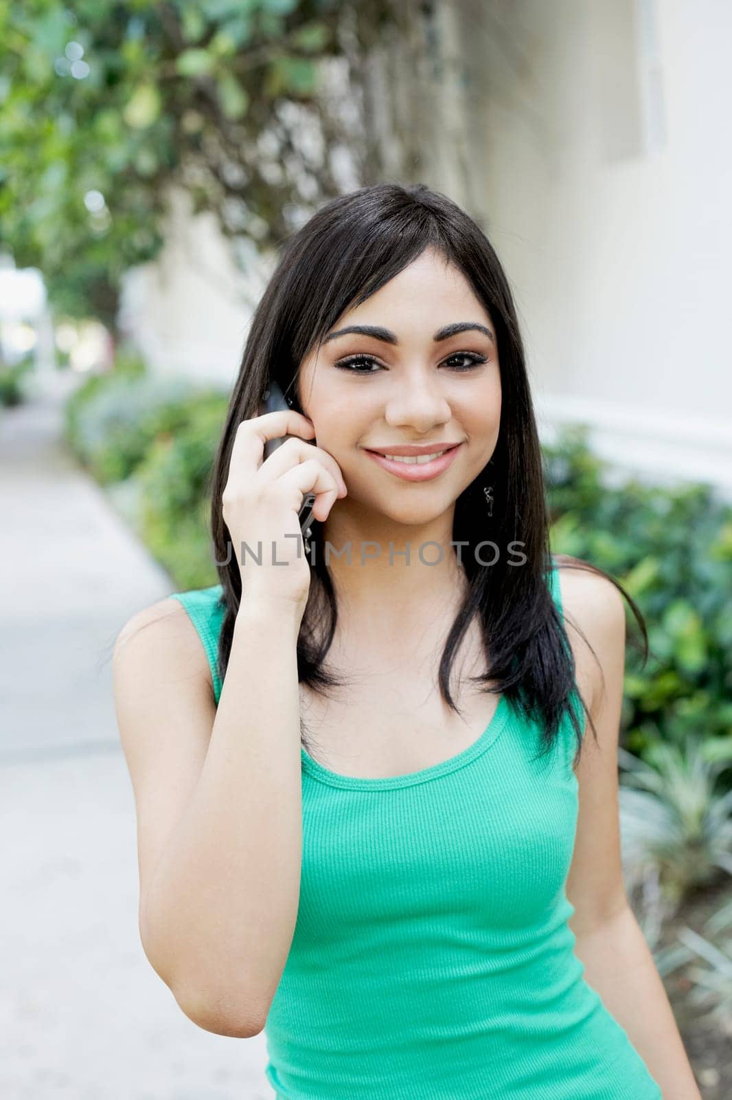 Portrait of a teenage girl talking on a mobile phone