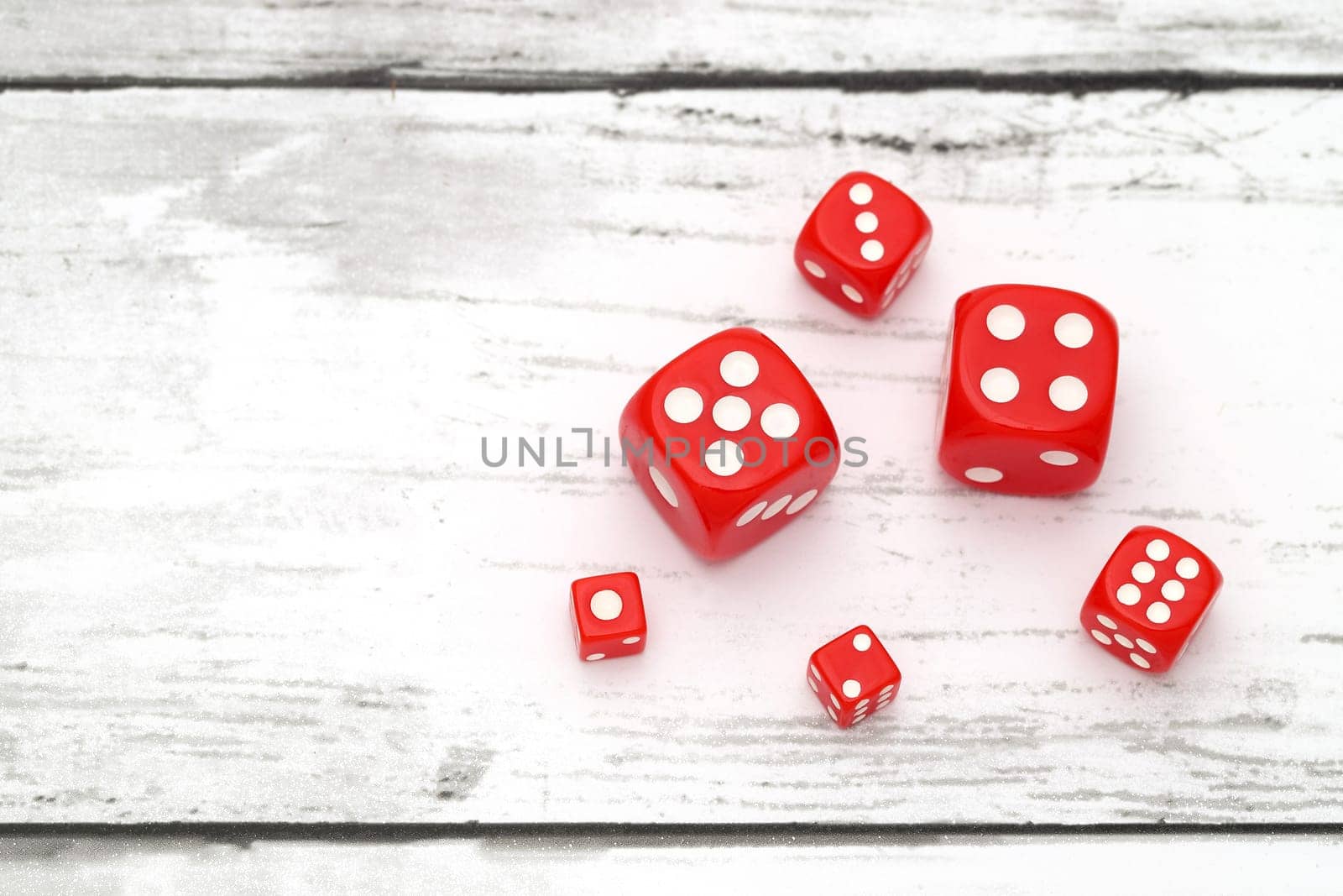 plastic colorful dices on a grungy white table