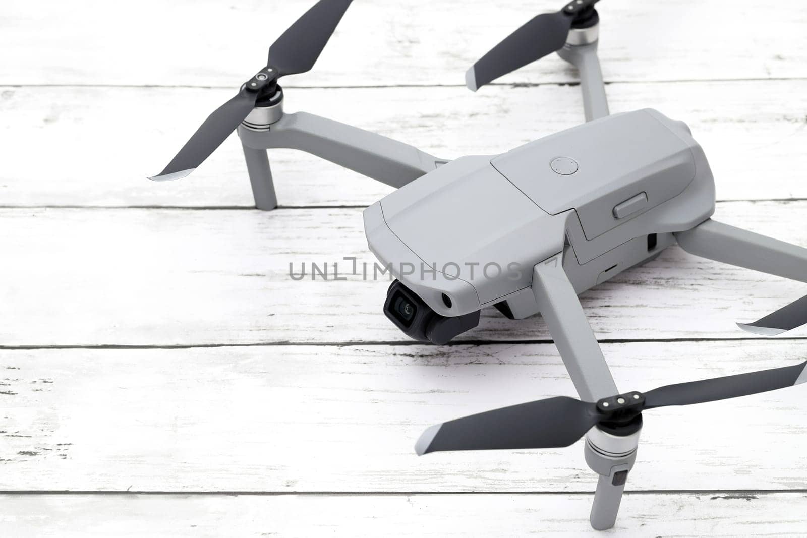 small drone copter on wooden white table. Close-up