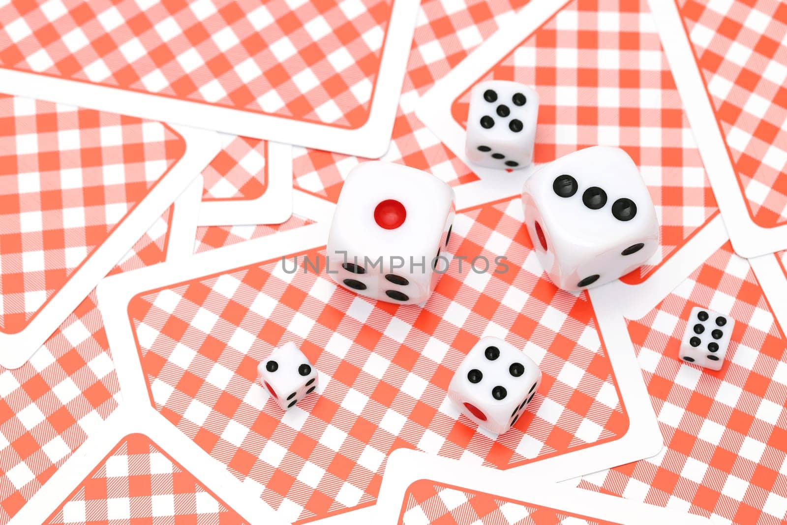 Dice on playing cards background. Game concept