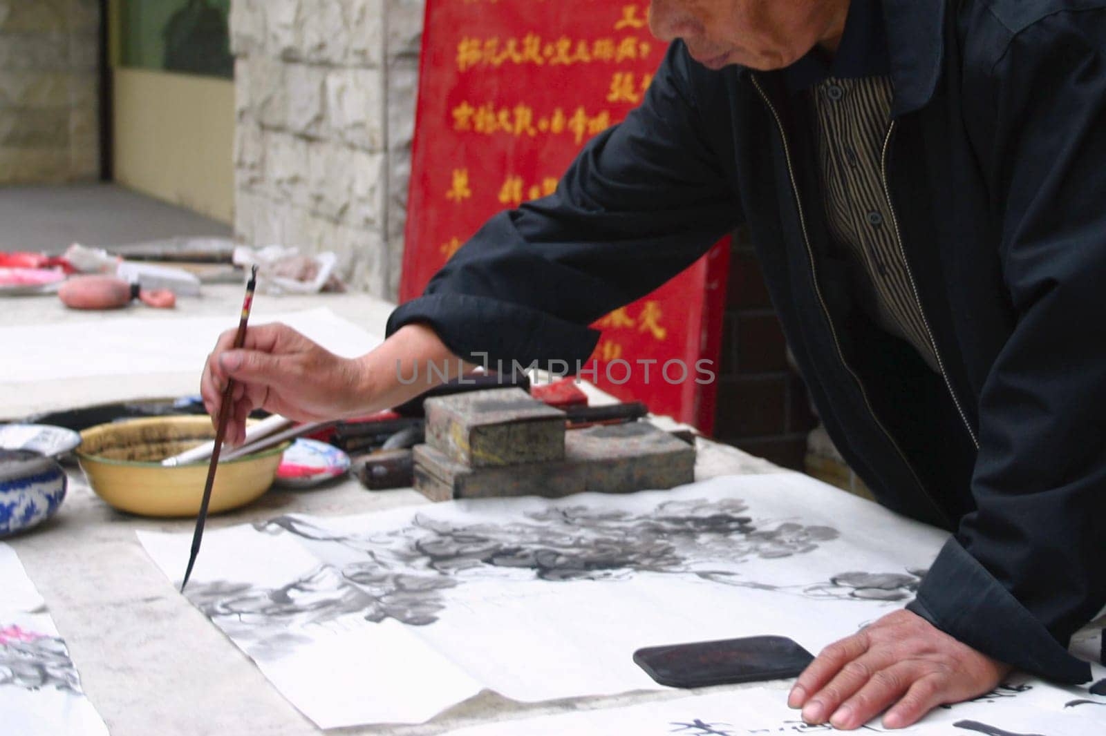 Mid section view of a man calligraphing, Beijing, China