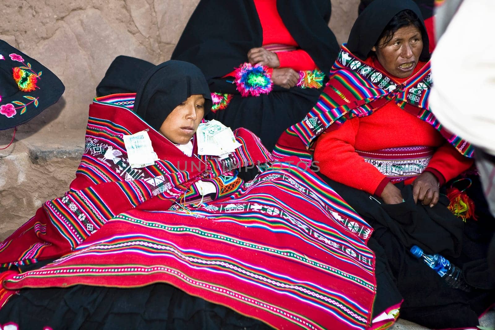 Mature woman sitting with a young woman at a wedding ceremony, Taquile Island, Lake Titicaca, Puno, Peru