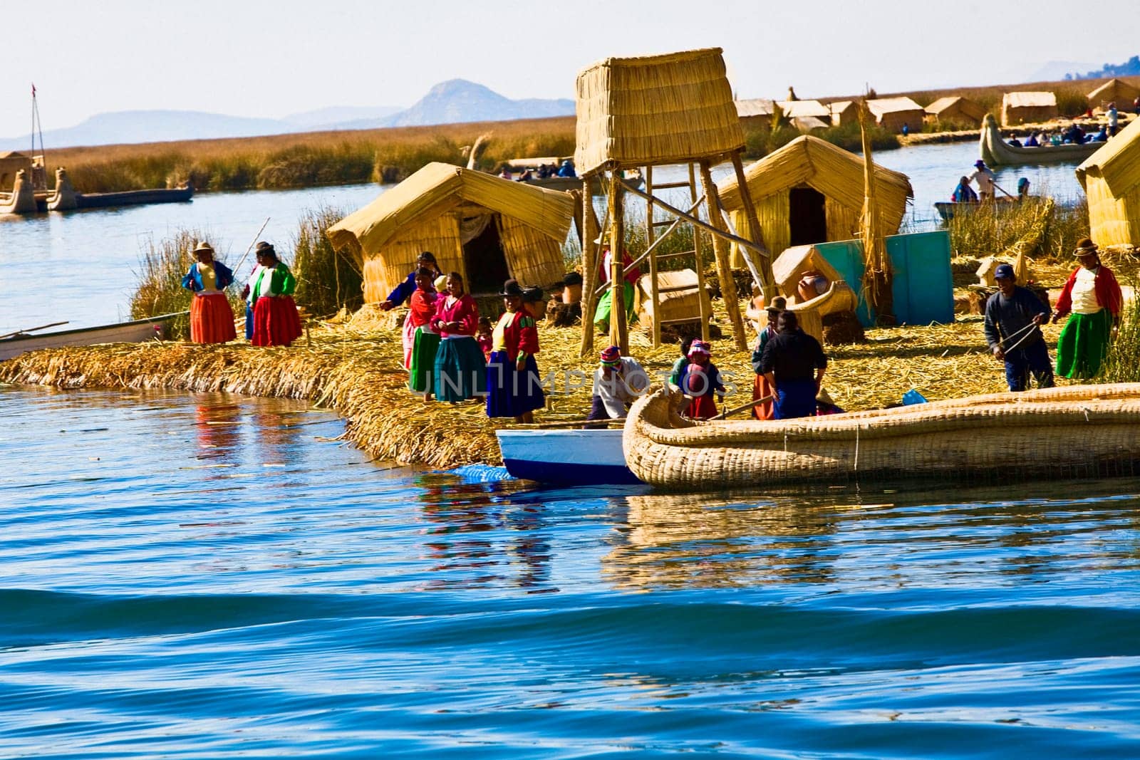Group of people at a lakeside, Lake Titicaca, Uros Floating Islands, Puno, Peru