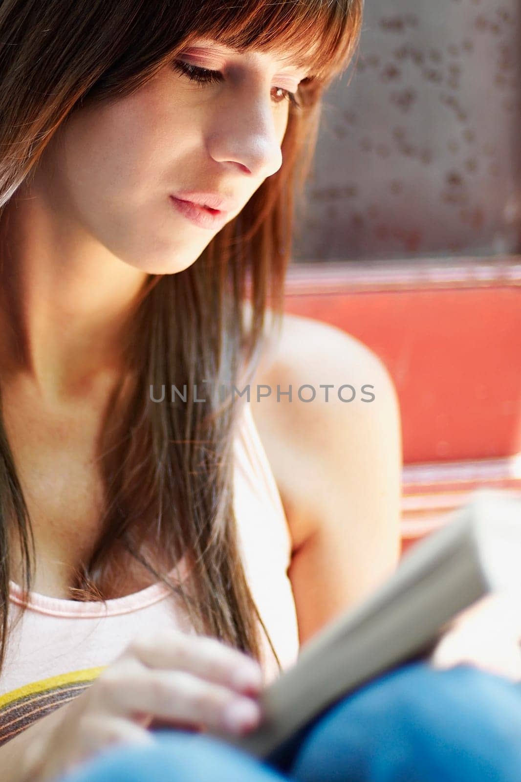 Close_up of a young woman reading a book