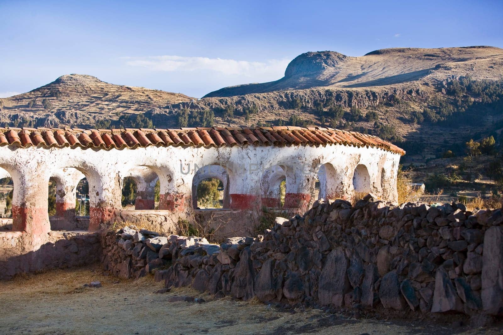 Stone wall in front of a building, Chicuito, Puno, Peru