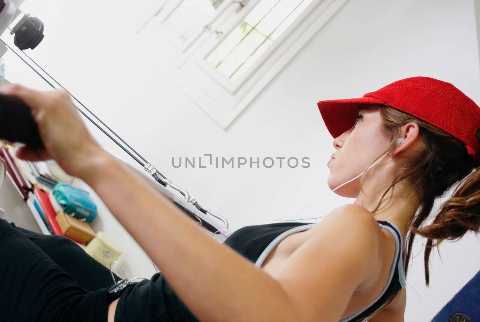 Side profile of a young woman exercising in a gym