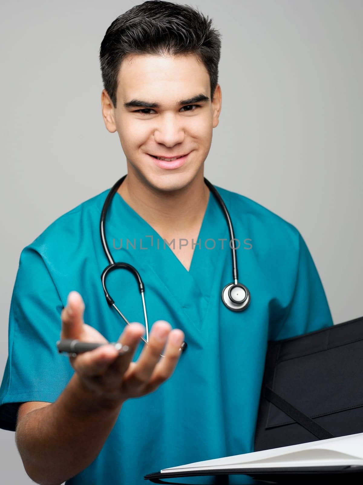 Portrait of a male surgeon holding a medical report and smiling