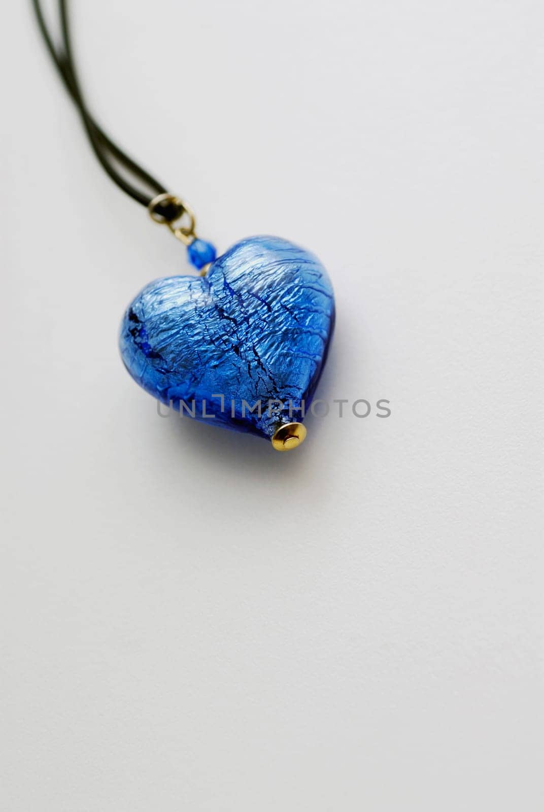 Close_up of a heart shaped pendant in a string