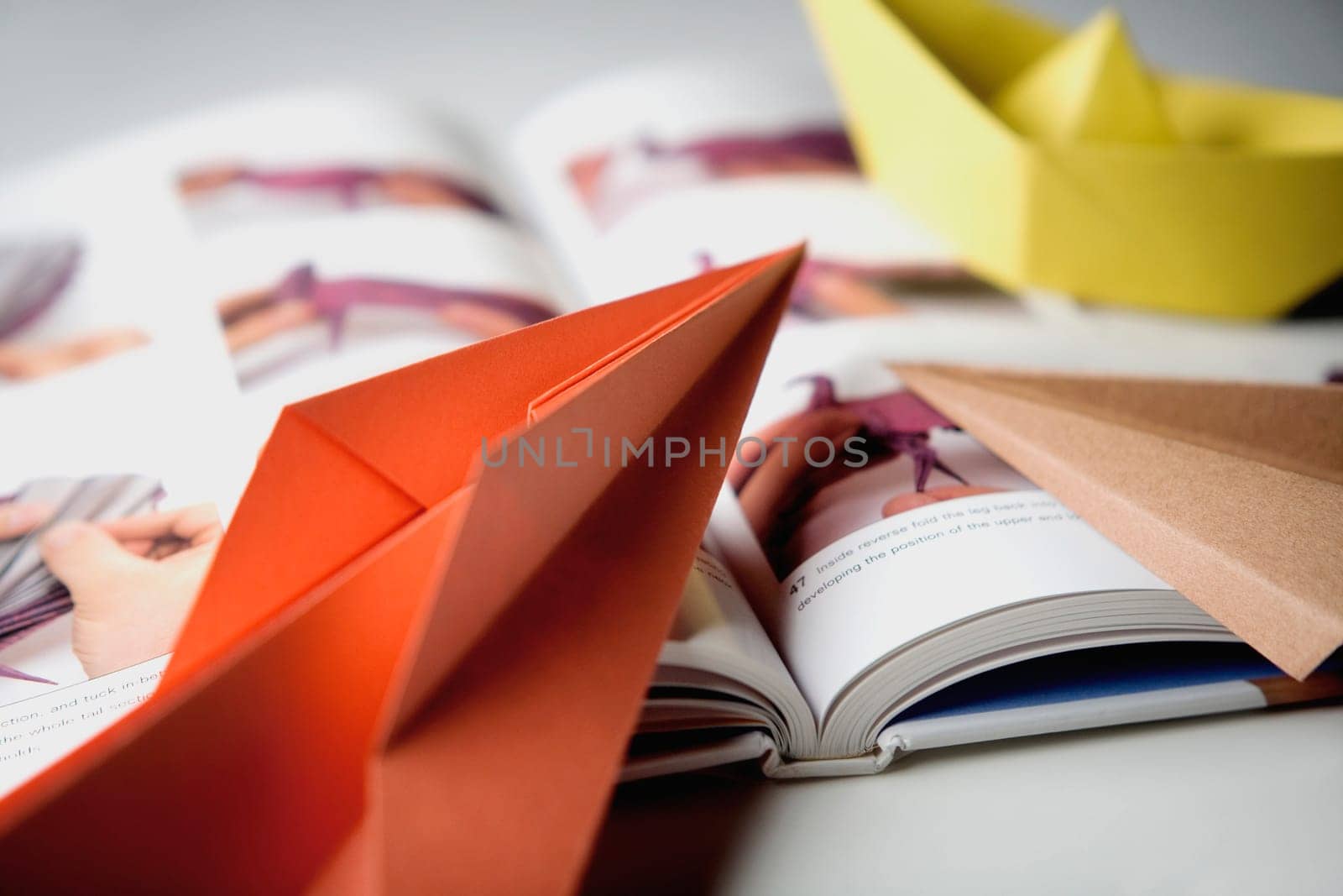 Close_up of a book with paper boats