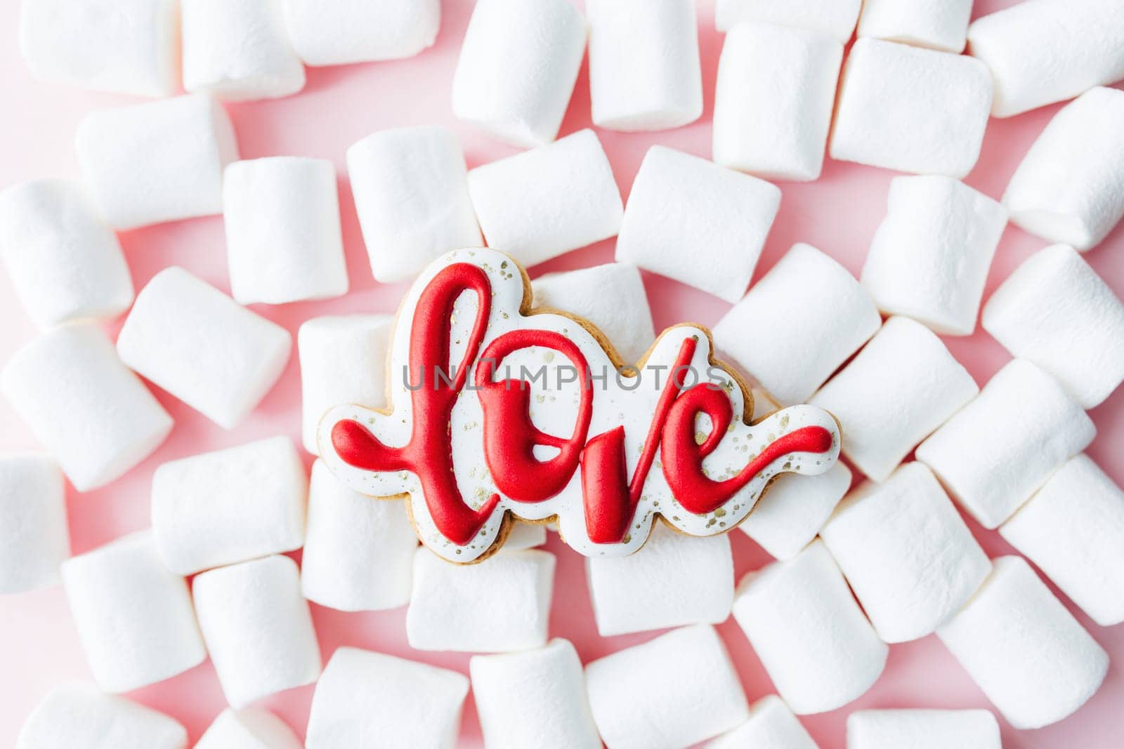 Gingerbread cookies love with white marshmallow. Valentine card. Pink background. High quality photo