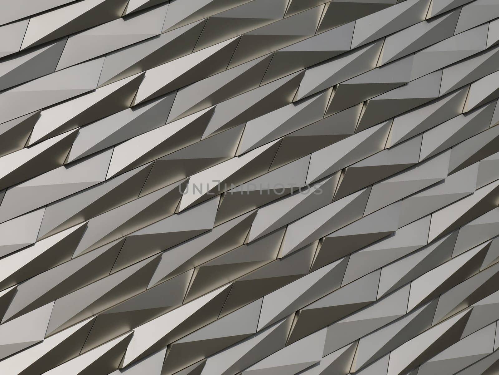 A futuristic,triangular,gray,silver colored,abstract and geometric background in 3d.