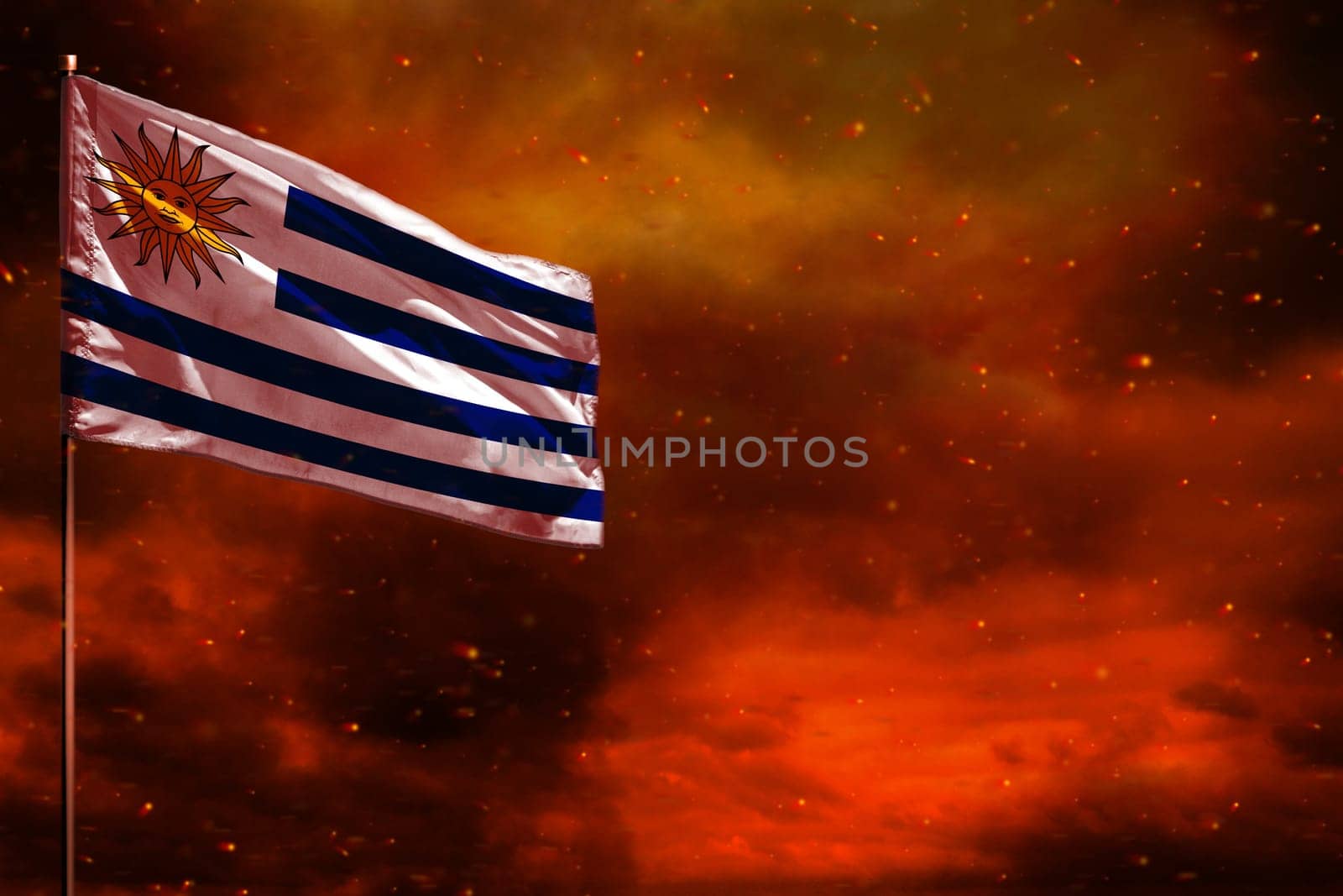 Fluttering Uruguay flag mockup with blank space for your data on crimson red sky with smoke pillars background. Uruguay problems concept.