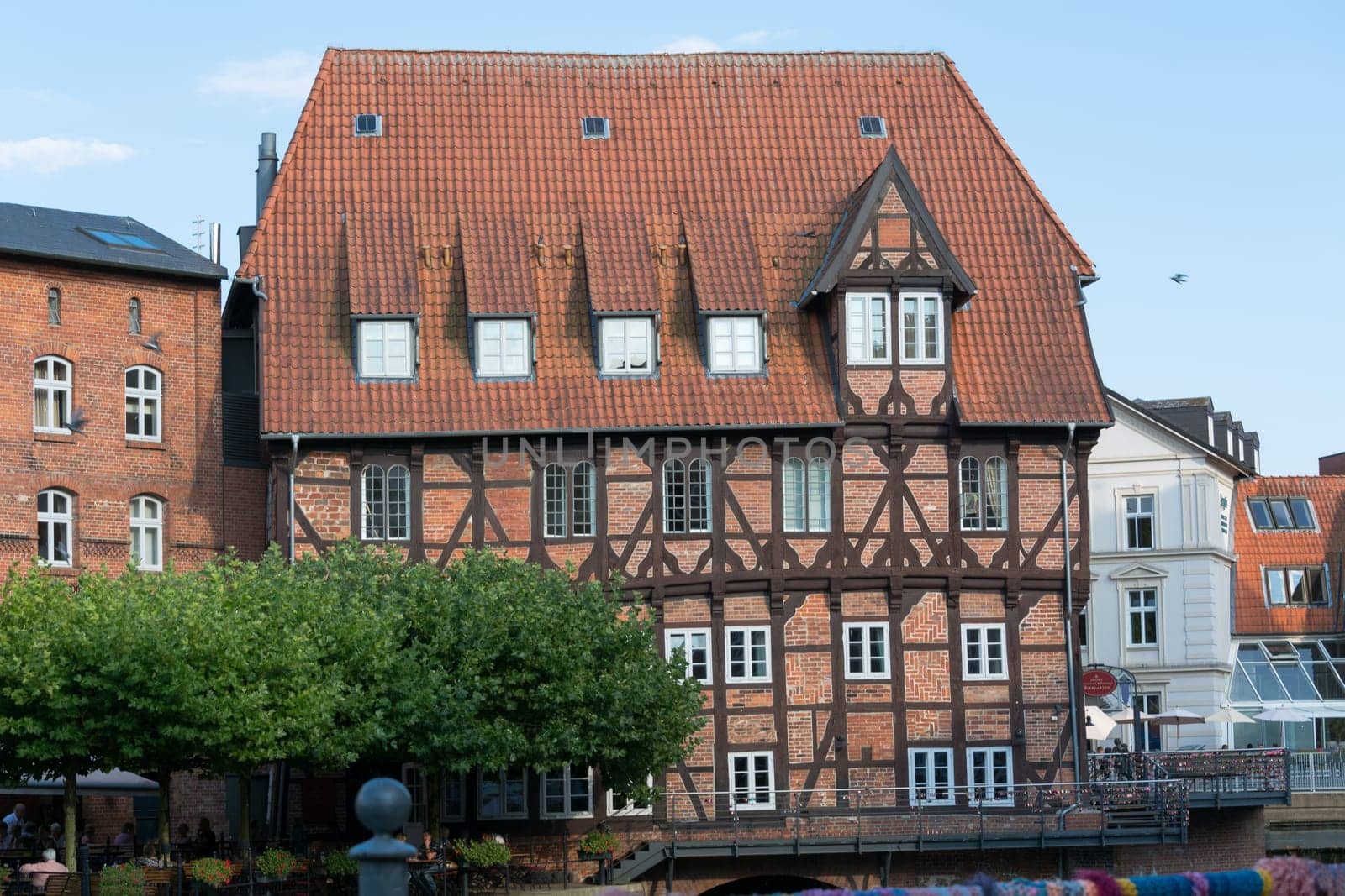 LÜNEBURG, NIEDERSACHSEN, GERMANY - JULI 27, 2018:..Half-timbered red brick houses near the river on the old harbor Lueneburg, Germany