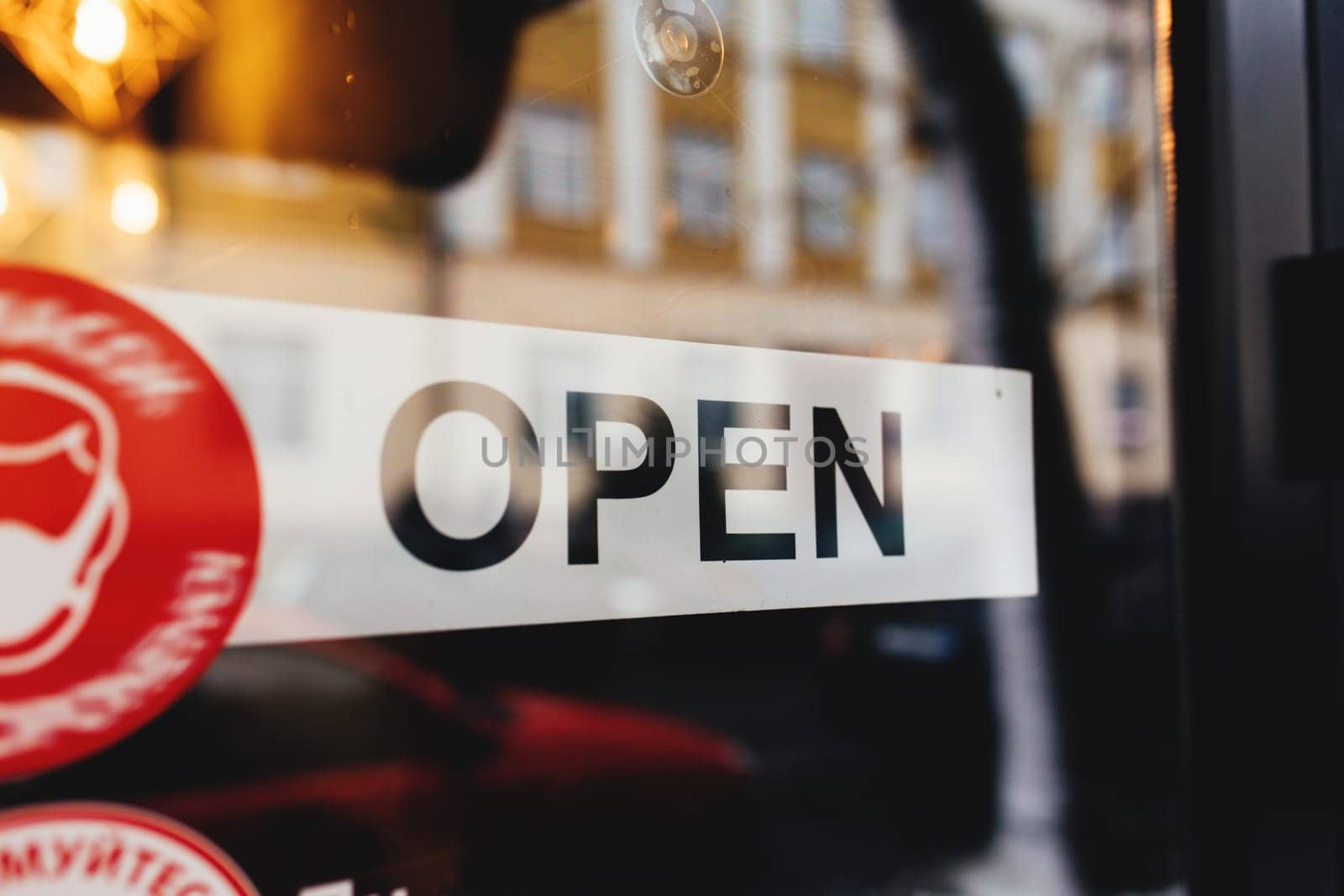 Signboard with Open text at the cafe through glass window. High quality photo