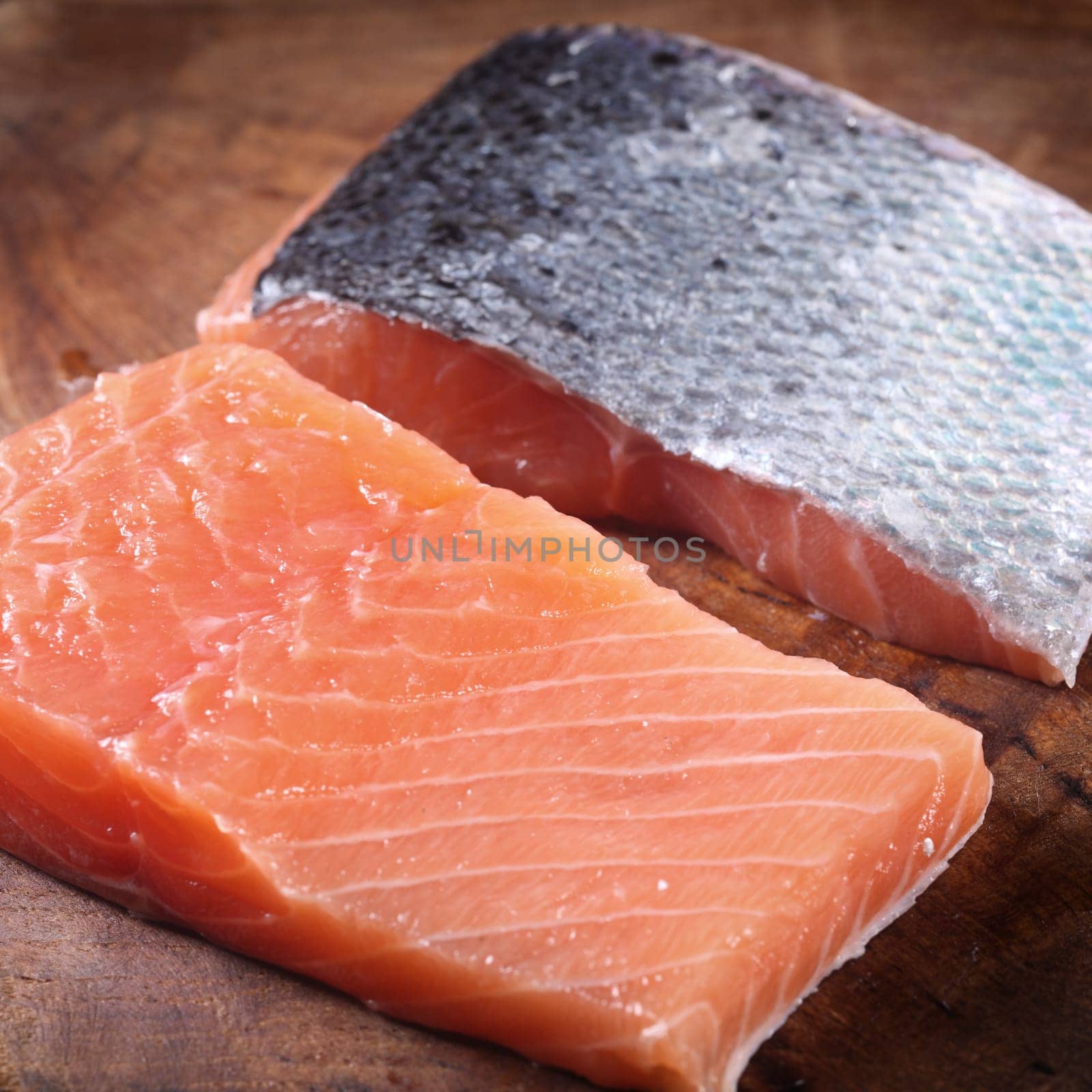 Close up Front and Back Slice of Fresh Fish Meat on Top of Wooden Chopping Board