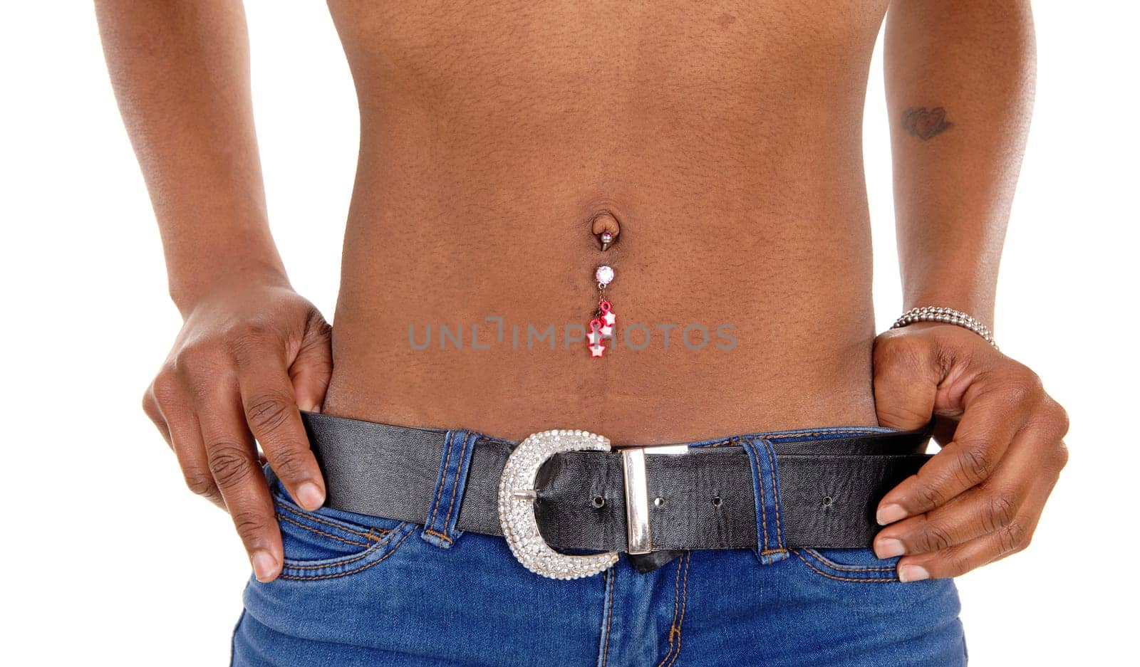 A closeup picture of the belly of a young black woman with jewellery and.jeans, isolated for white background..