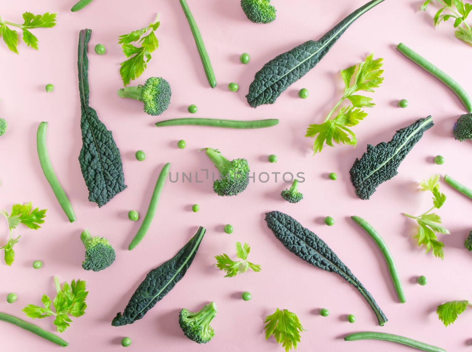 top view of fresh green vegetables on the pink table